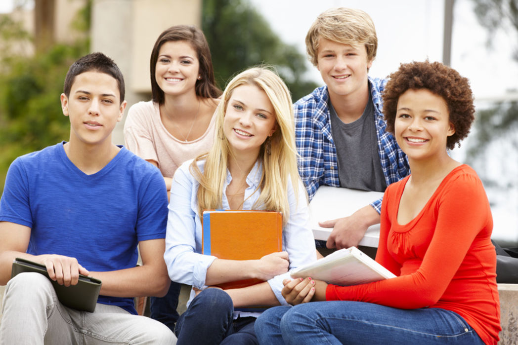 Multi racial student group sitting outdoors Foto: Monkey_Business Fotolia.com